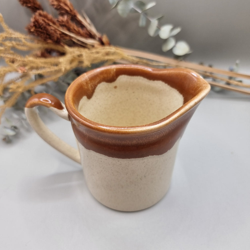Titian Pottery NZ milk jug with caramel brown drip glaze and speckled finish.