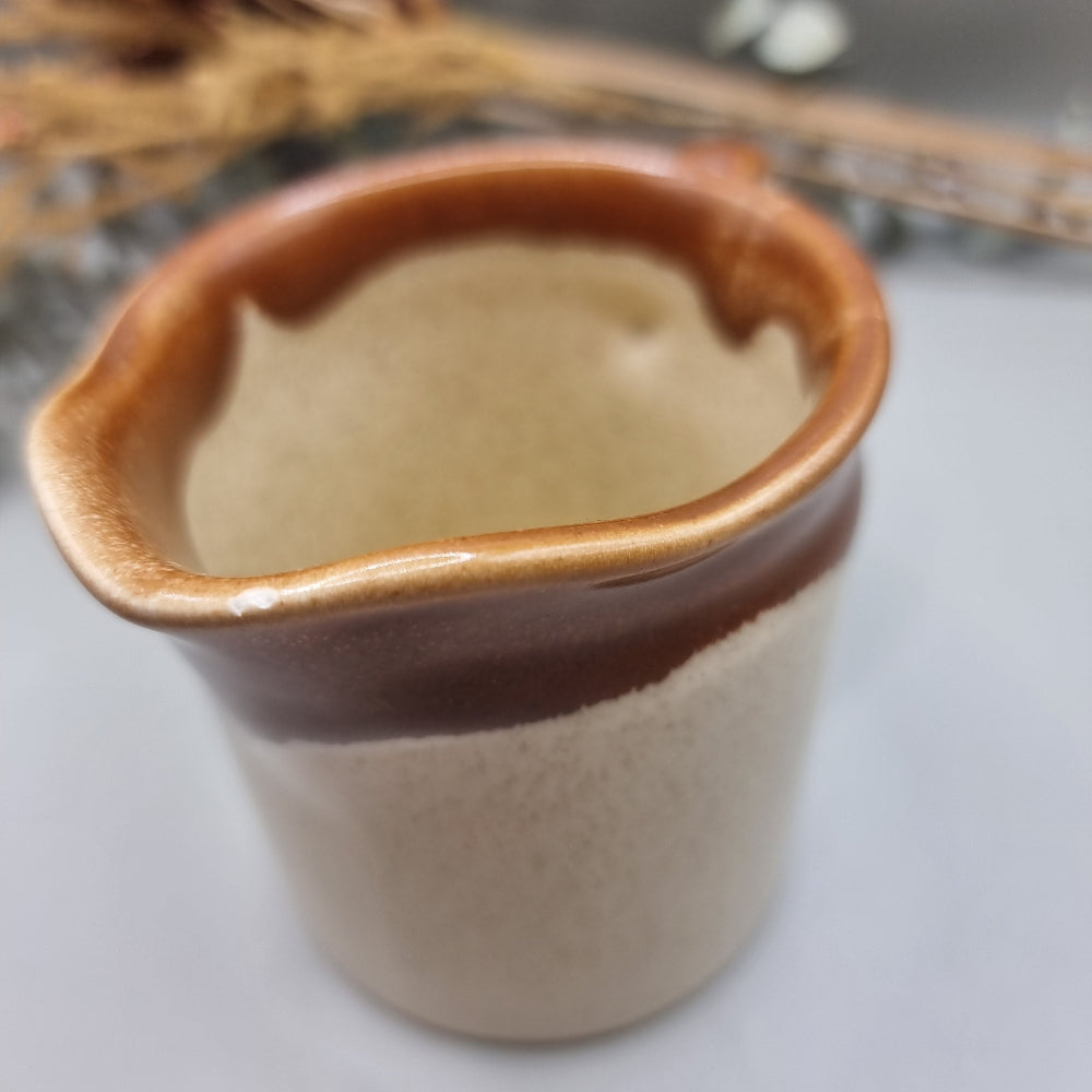 Titian Pottery NZ milk jug with caramel brown drip glaze and speckled finish.
