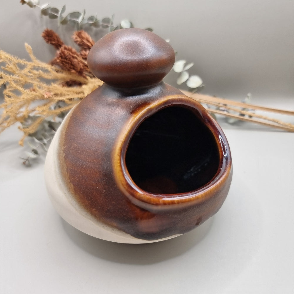 Royal Oak pottery salt pig with brown glaze and floral pattern