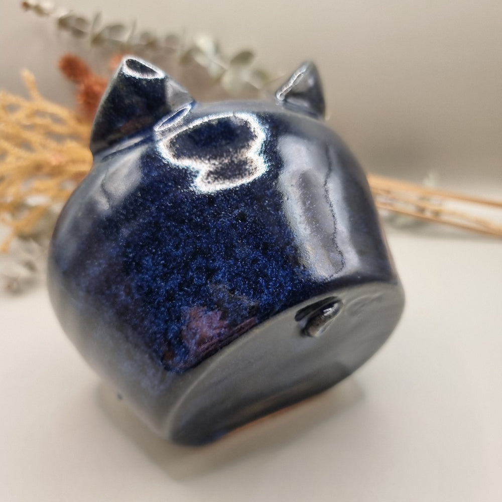 Ceramic salt pig with blue glaze and a spoon for easy seasoning