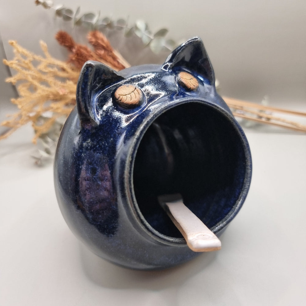 Ceramic salt pig with blue glaze and a spoon for easy seasoning