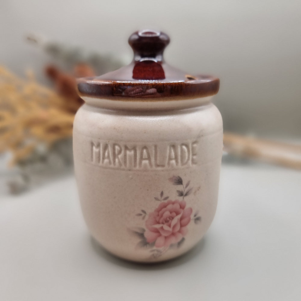 Ceramic marmalade jar and spoon holder with pink rose design and brown glazed rims.
