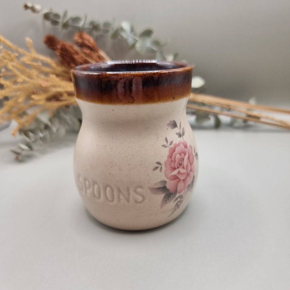 Ceramic marmalade jar and spoon holder with pink rose design and brown glazed rims.
