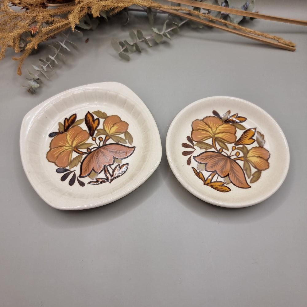 Two Palissy side plates with 70s floral pattern in orange, brown and yellow