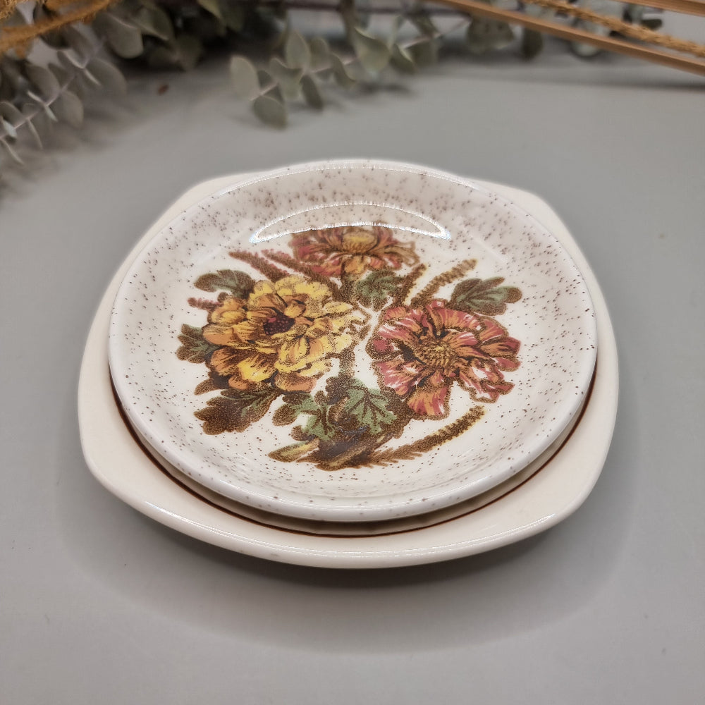Pair of Palissy dishes with floral designs – one speckled glaze, one Springtime blossom pattern.