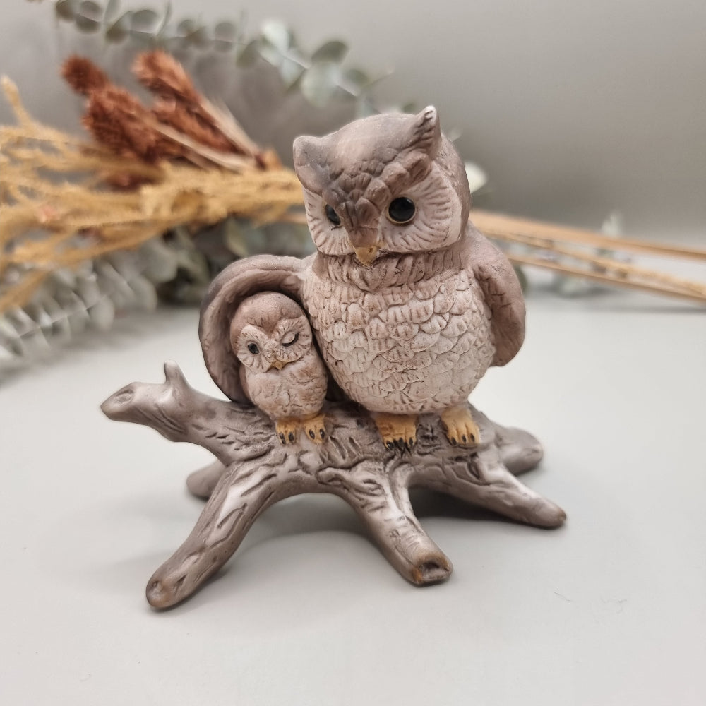 Ceramic ornament of a parent owl and baby owl perched on a branch.