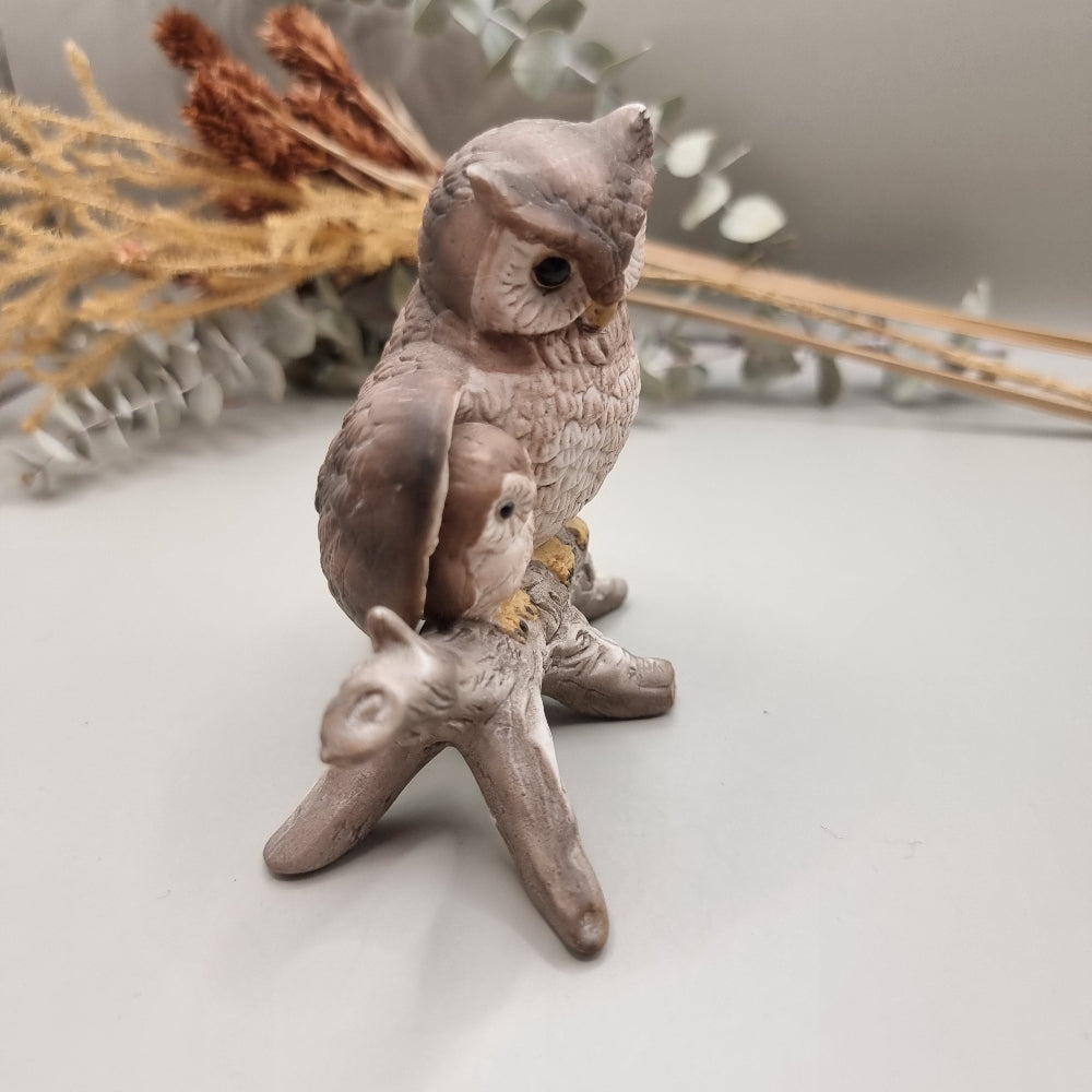 Ceramic ornament of a parent owl and baby owl perched on a branch.