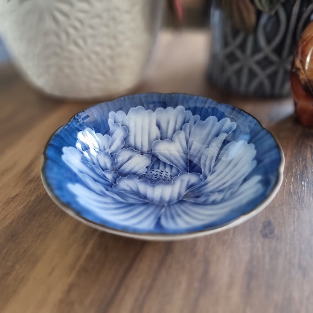Blue porcelain dish with large blooming flower design and scalloped edge