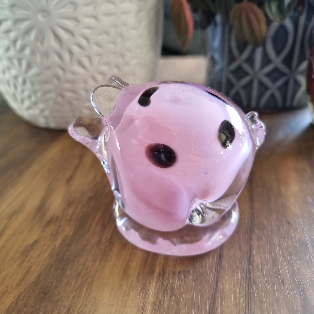 Pink and clear glass pig figurine with swirled design and clear base.