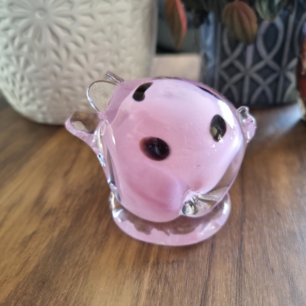 Pink and clear glass pig figurine with swirled design and clear base.