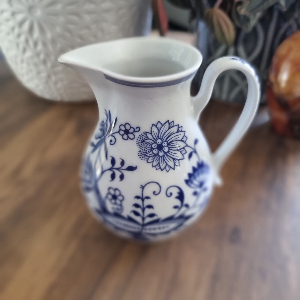 Czech Bohemian pottery jug with blue floral design on white ceramic and elegant curved handle
