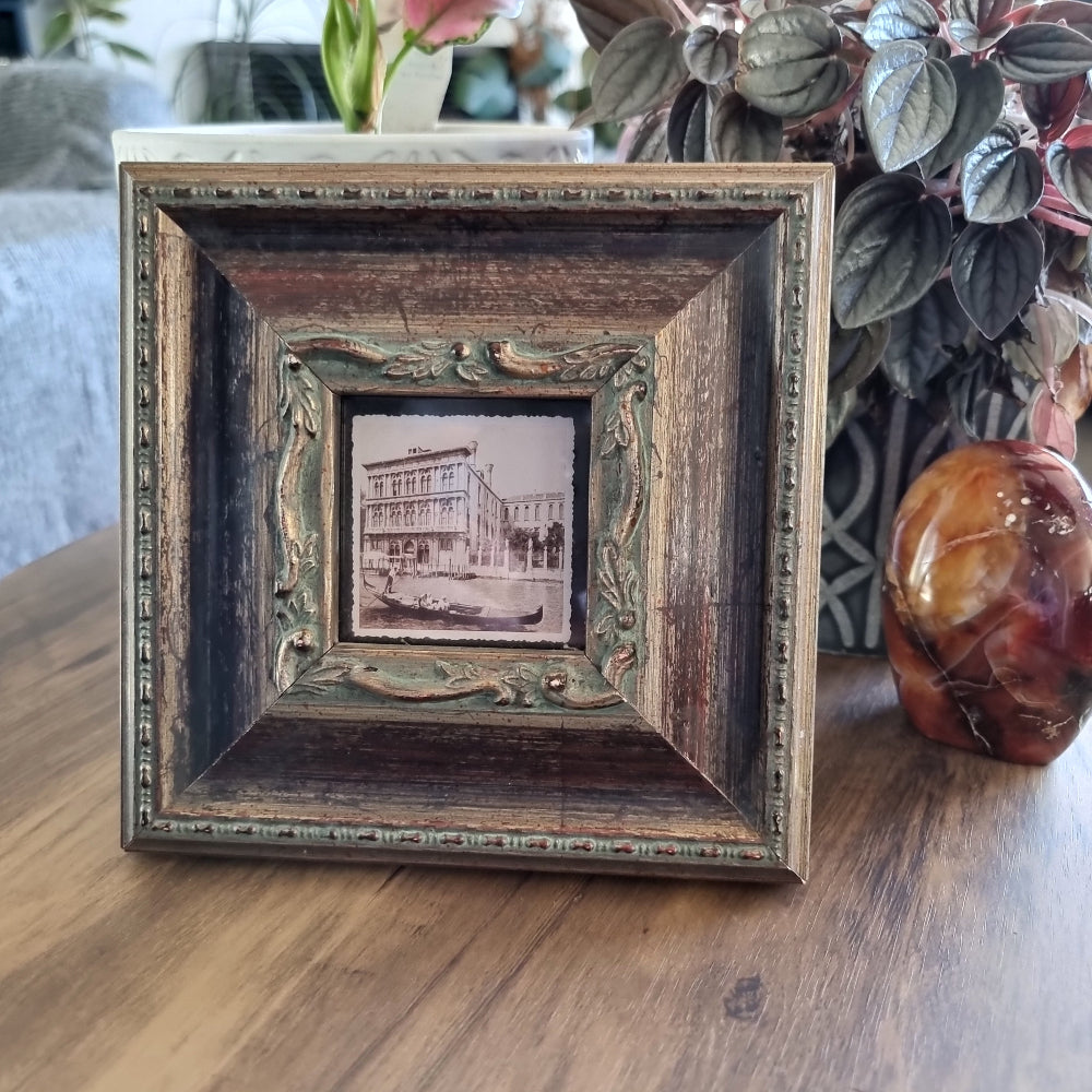 Ornate wood and gold photo frame with vintage Venice gondola print.