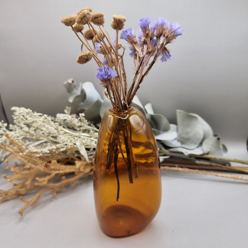 Amber handblown vase with smooth curved shape and small top opening.