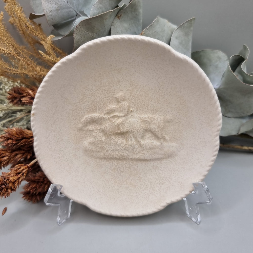 Spode Velamour plate with embossed horse and rider motif on a textured cream glaze.