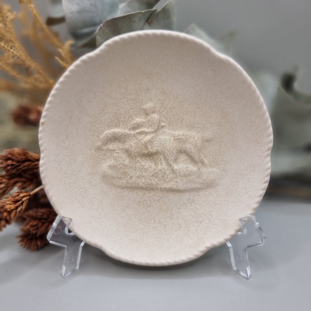 Spode Velamour plate with embossed horse and rider motif on a textured cream glaze.