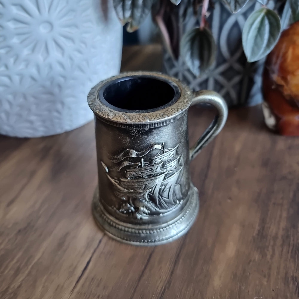 Pewter-look tankard with embossed sailing ship design and handle