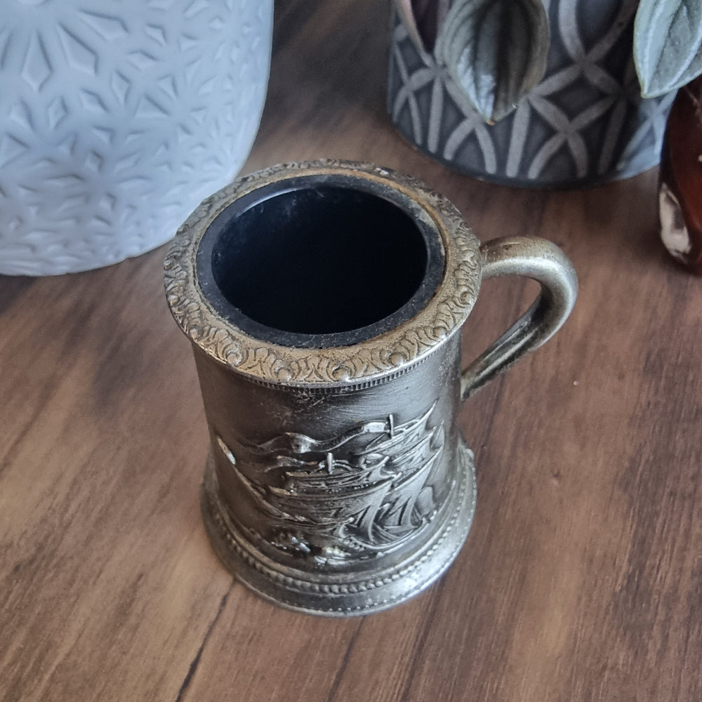 Pewter-look tankard with embossed sailing ship design and handle