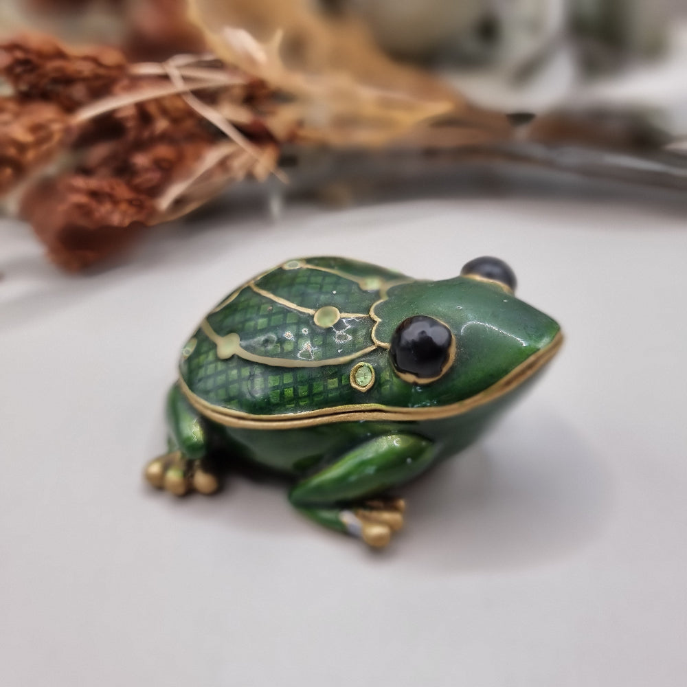 Green enamel frog trinket box with gold trim and rhinestones.