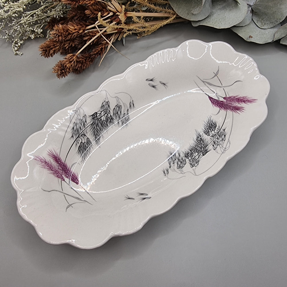 Clarice Cliff Royal Staffordshire oval dish with scalloped edge and wheat design in black, grey, and purple.