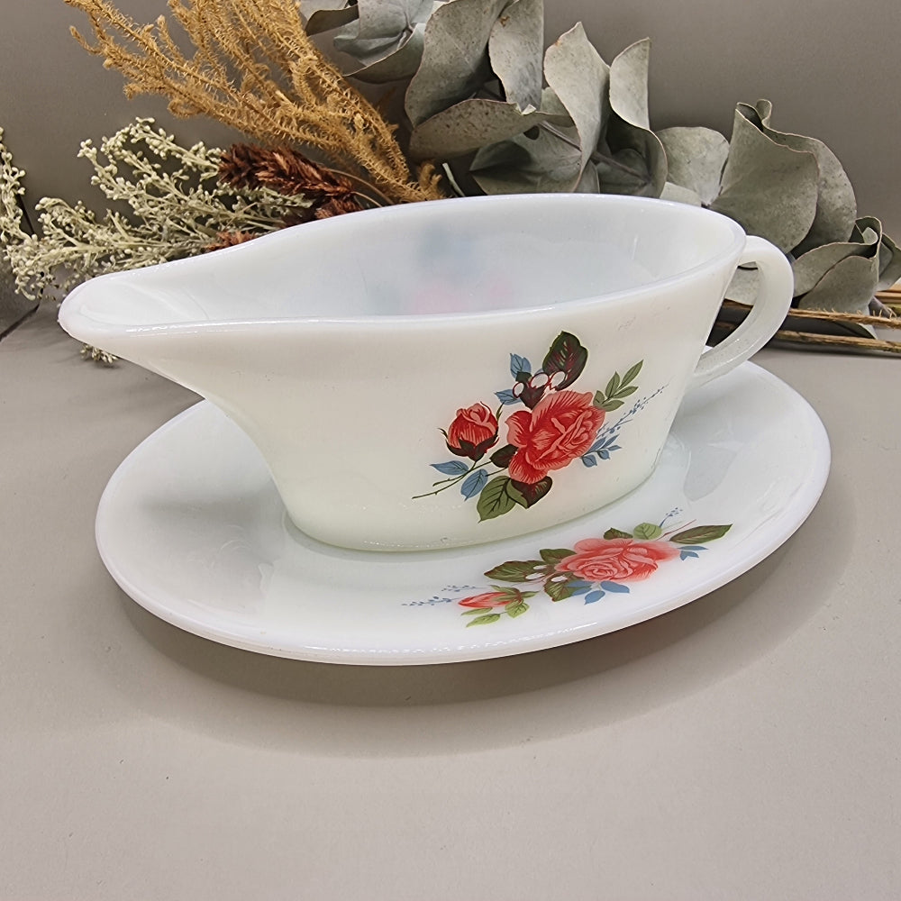 Vintage milk glass-style gravy boat with pink rose floral design and underplate