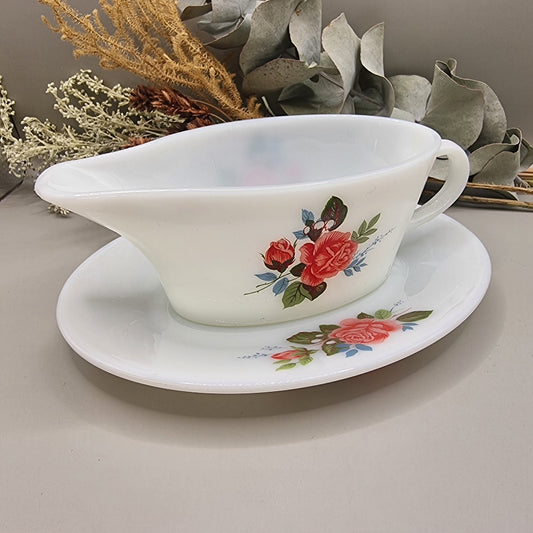 Vintage milk glass-style gravy boat with pink rose floral design and underplate