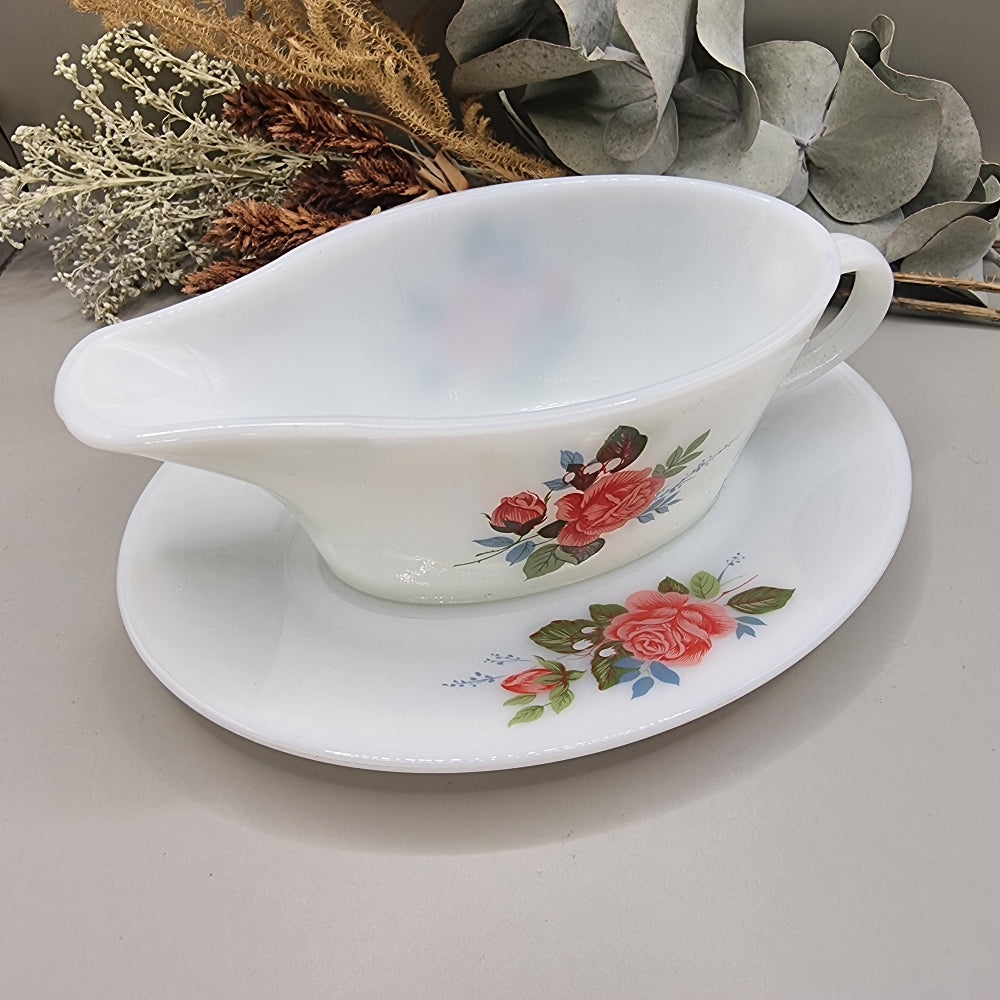 Vintage milk glass-style gravy boat with pink rose floral design and underplate
