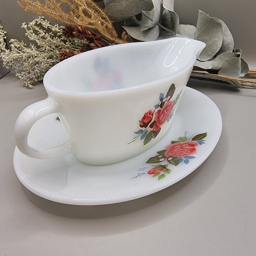 Vintage milk glass-style gravy boat with pink rose floral design and underplate