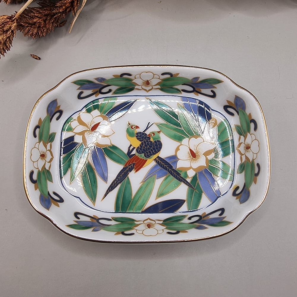 Chinese porcelain dish with colourful birds, green leaves, white flowers and gold trim.