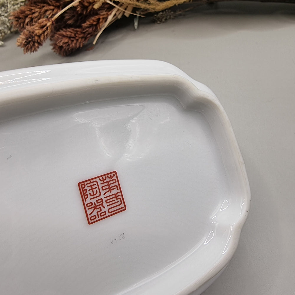 Chinese porcelain dish with colourful birds, green leaves, white flowers and gold trim.