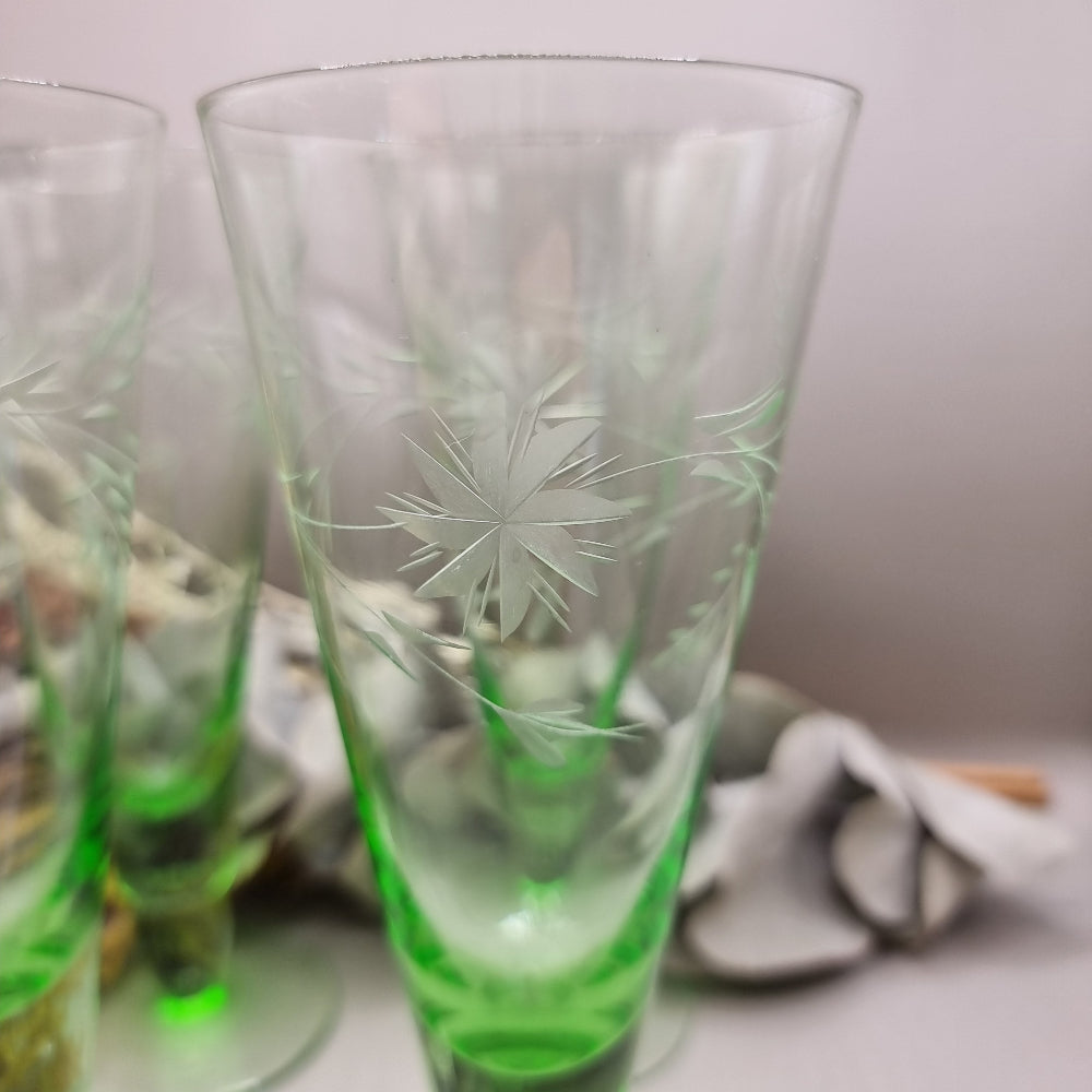 Set of 4 tall green etched flutes with starburst and leaf design.
