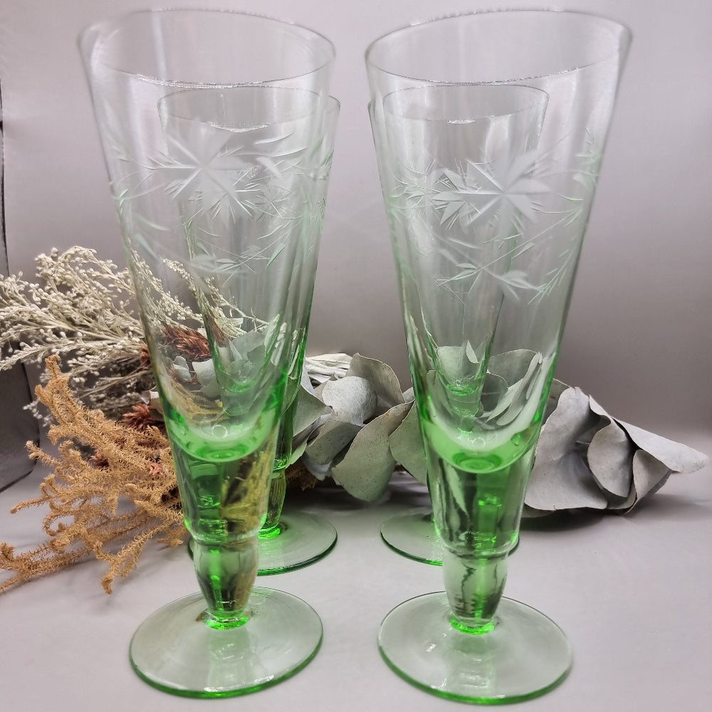 Set of 4 tall green etched flutes with starburst and leaf design.