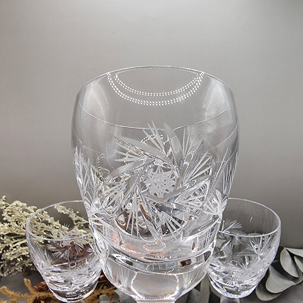 Set of four cut crystal wine goblets with intricate starburst design