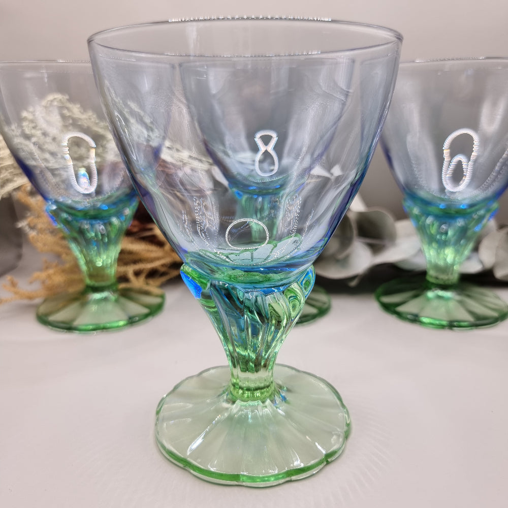 Set of 4 Bormioli Rocco Bahia goblets with blue bowls and green scalloped stems.