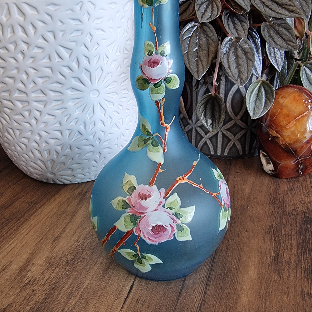 Blue satin glass vase with hand-painted pink roses and green leaves