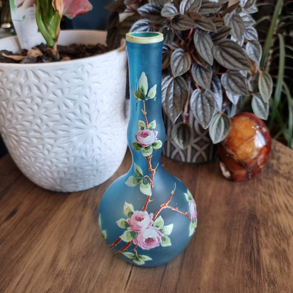 Blue satin glass vase with hand-painted pink roses and green leaves