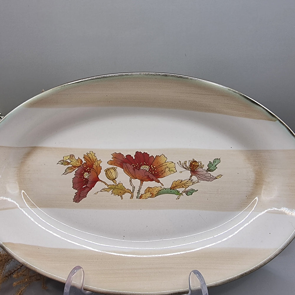 Robert Gordon oval stoneware plate with red poppies and beige bands.