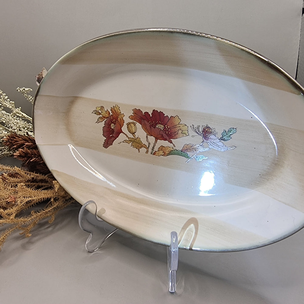Robert Gordon oval stoneware plate with red poppies and beige bands.