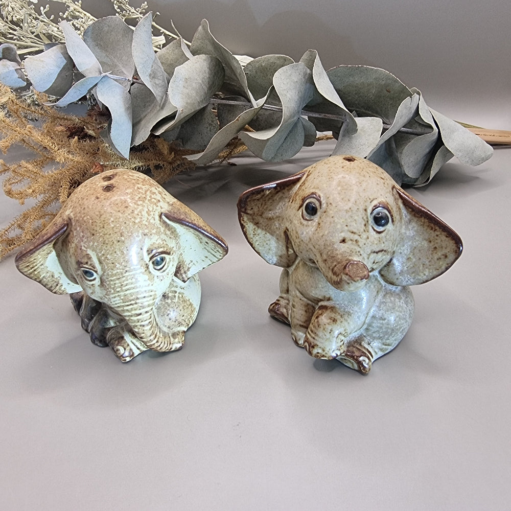 Vintage ceramic elephant salt and pepper shakers with speckled glaze and sweet expressions.
