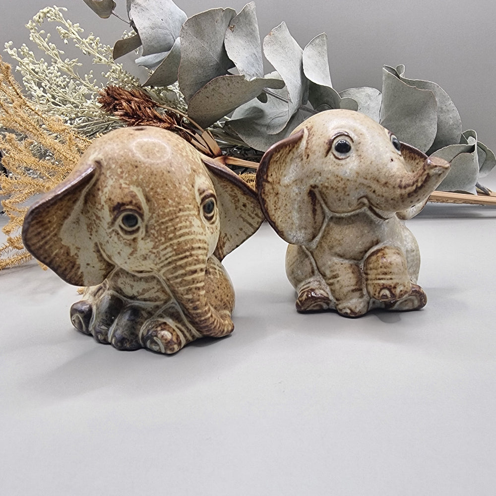Vintage ceramic elephant salt and pepper shakers with speckled glaze and sweet expressions.