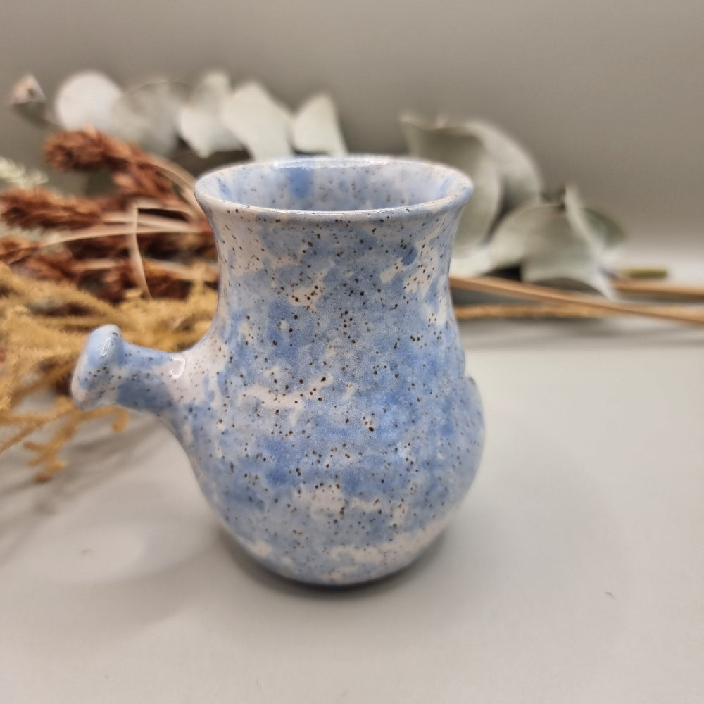 Vintage pottery face jug with blue speckle glaze and smiling face