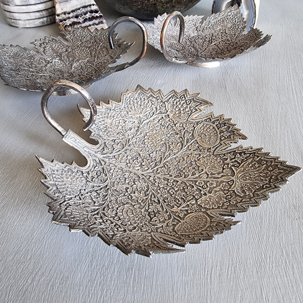 Set of 3 silver-toned metal leaf-shaped dishes with intricate engraved floral patterns