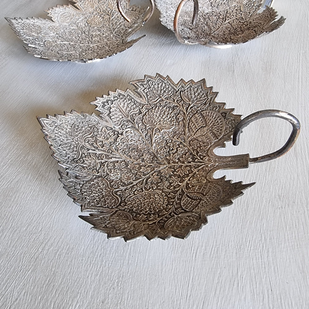 Set of 3 silver-toned metal leaf-shaped dishes with intricate engraved floral patterns