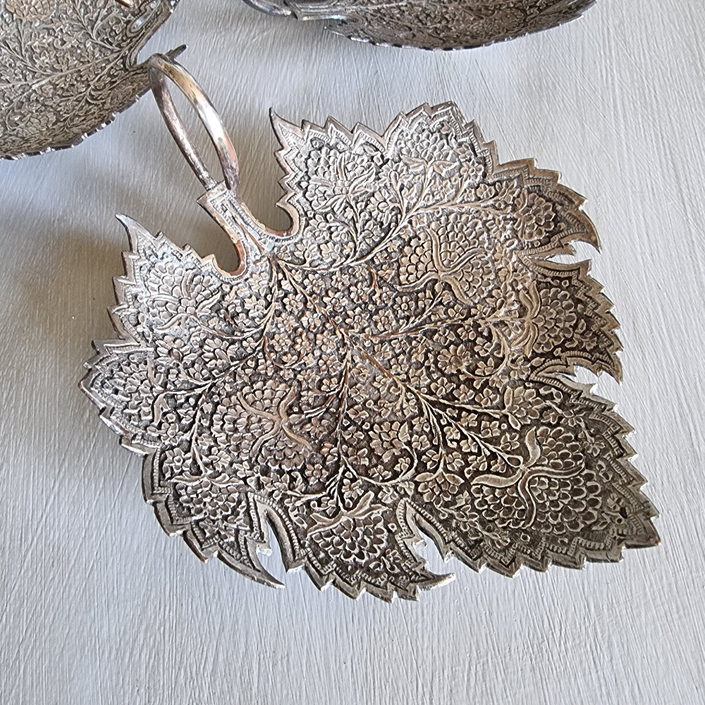 Set of 3 silver-toned metal leaf-shaped dishes with intricate engraved floral patterns