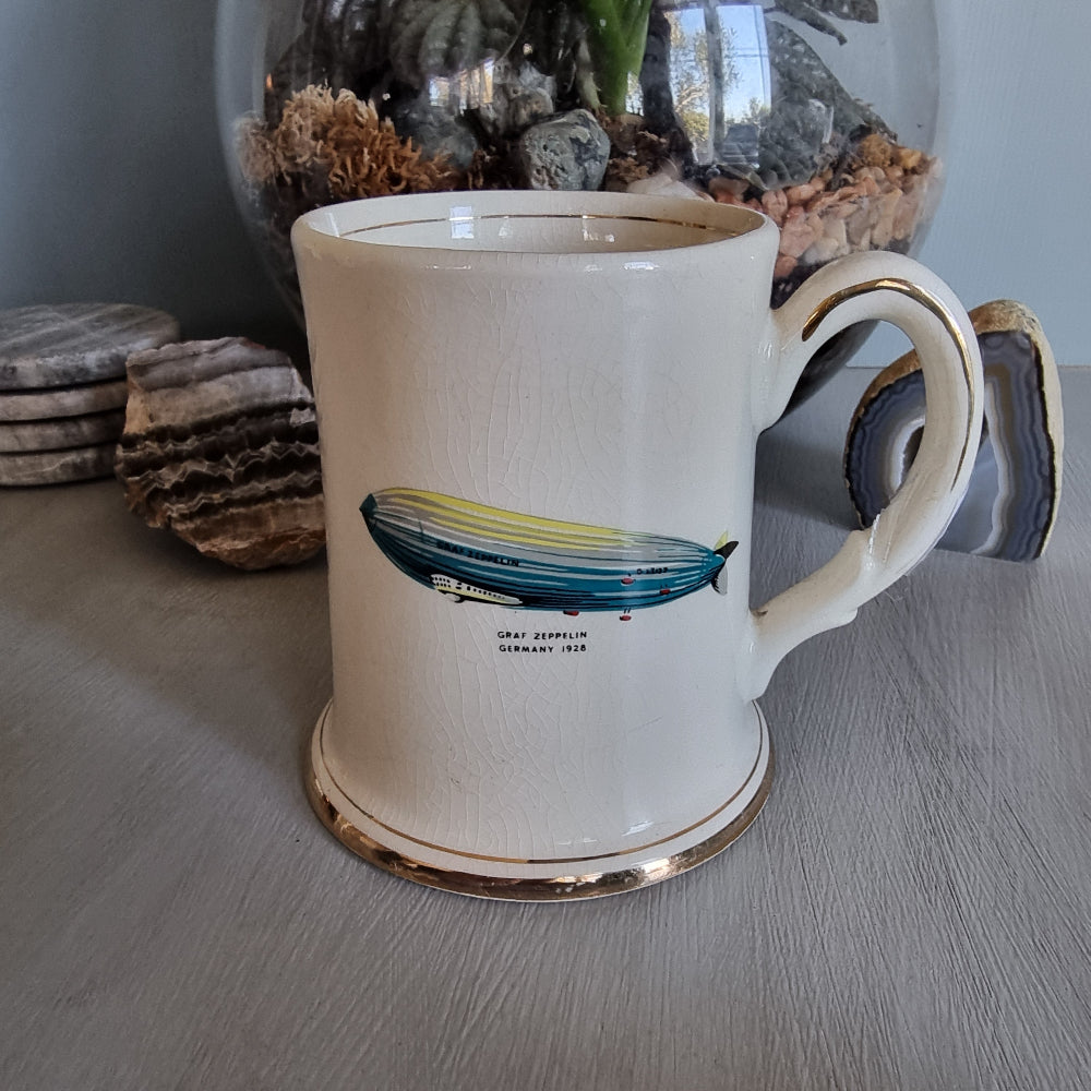Vintage mug with Graf Zeppelin and Viking ship illustrations, gold trim and crackle glaze.