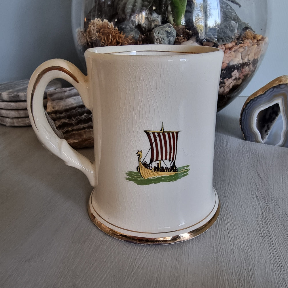 Vintage mug with Graf Zeppelin and Viking ship illustrations, gold trim and crackle glaze.