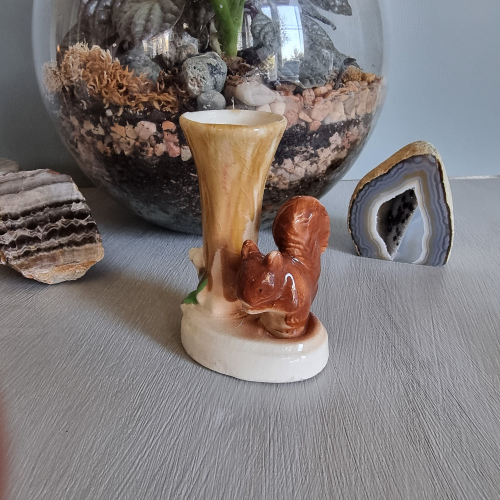 Vintage ceramic bud vase featuring a brown squirrel beside a tree stump with earthy glaze and crazing.