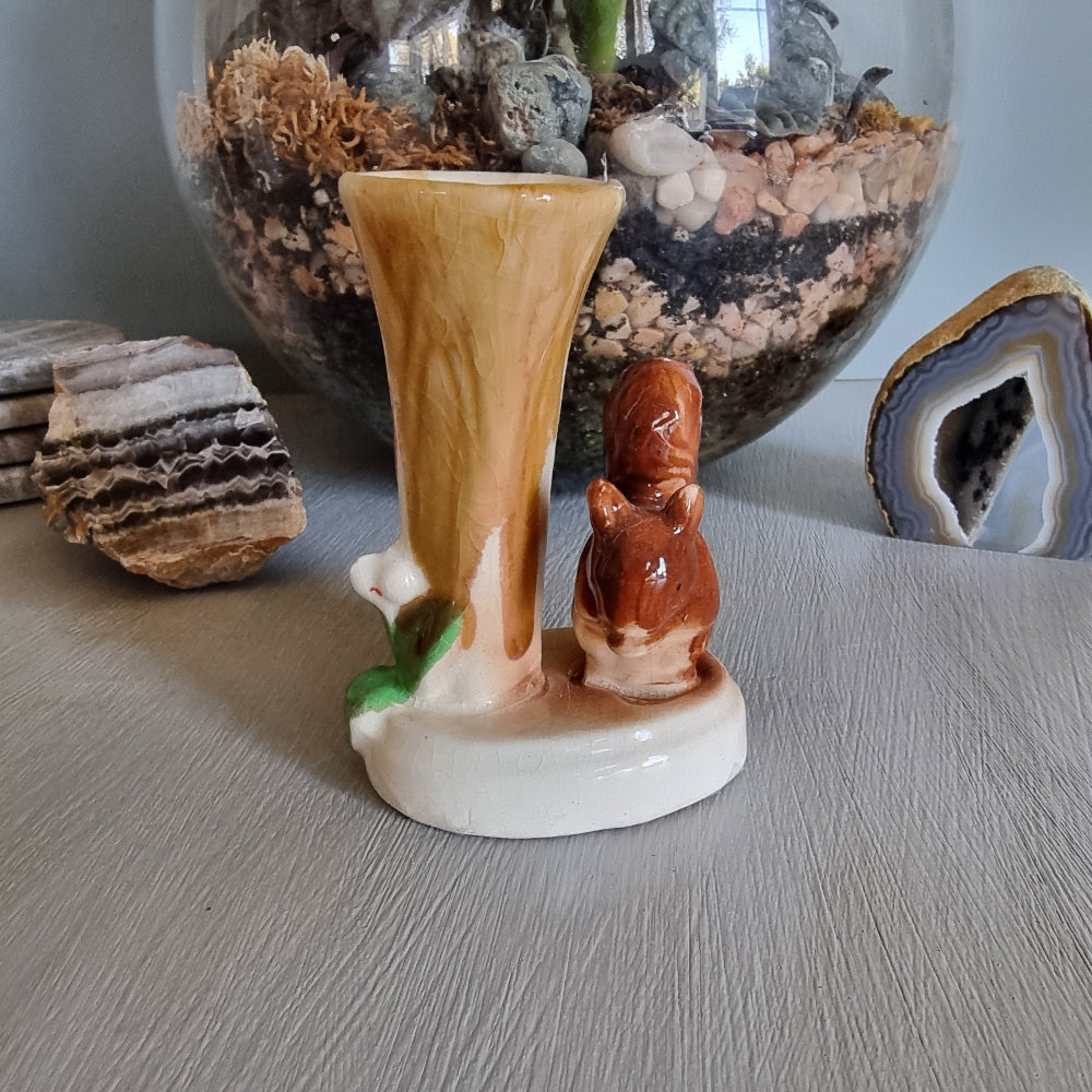 Vintage ceramic bud vase featuring a brown squirrel beside a tree stump with earthy glaze and crazing.