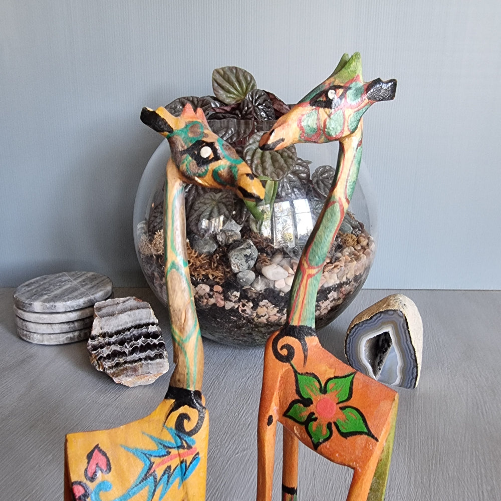 Pair of hand-painted wooden giraffe figurines with colourful folk art designs.