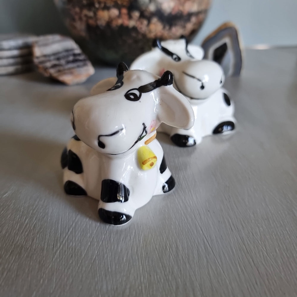 Ceramic cow salt and pepper shakers with black spots and yellow cowbells