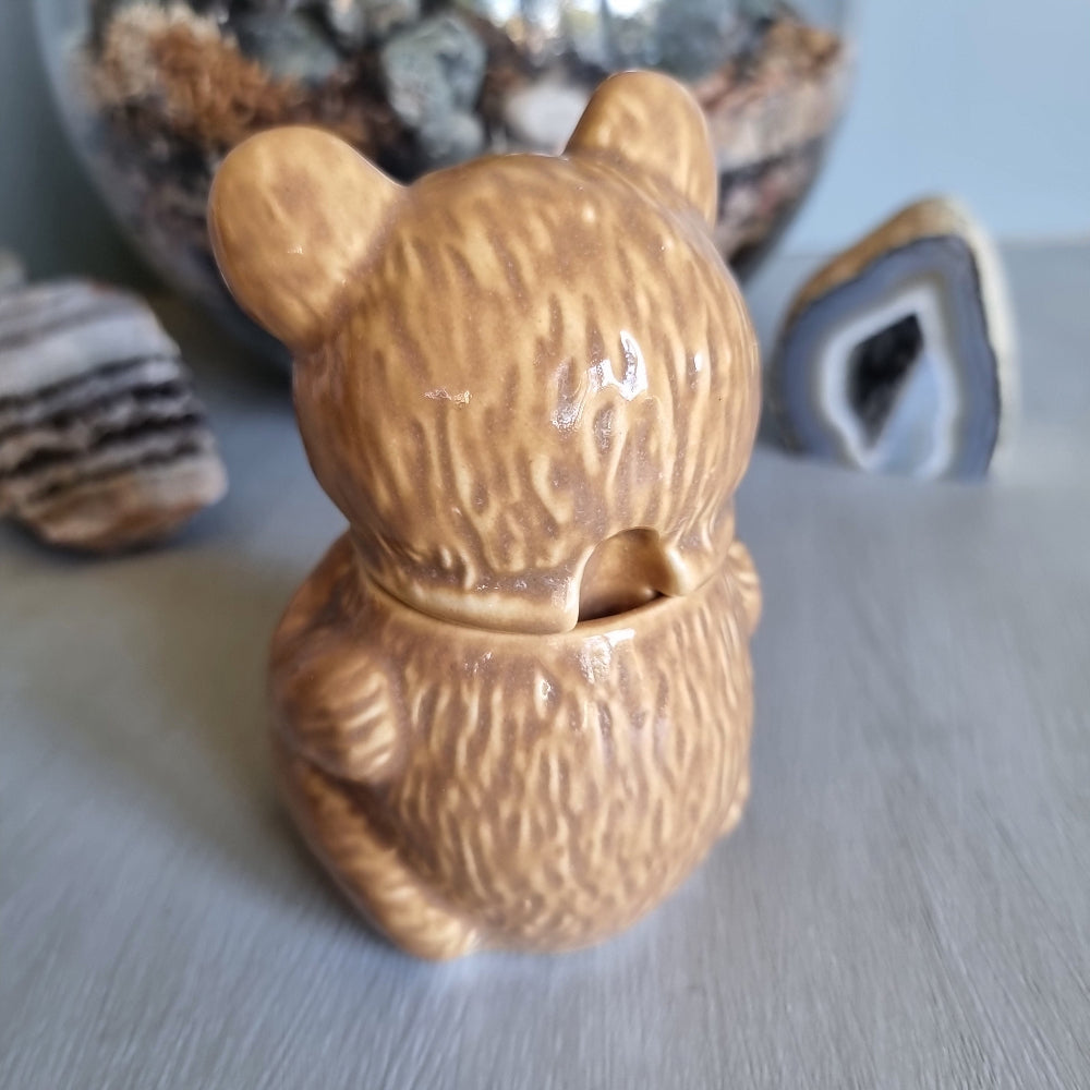 Vintage ceramic bear honey pot with bowtie and removable head for storing honey.